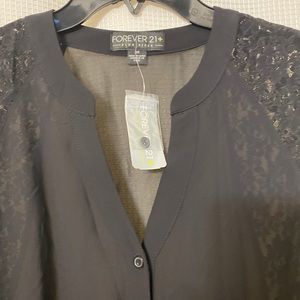 Black top with lace accent. Long sleeve.